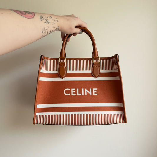 A handmade upcycled Celine dust bag crafted into a large tote bag in terracotta brown and white striped fabric